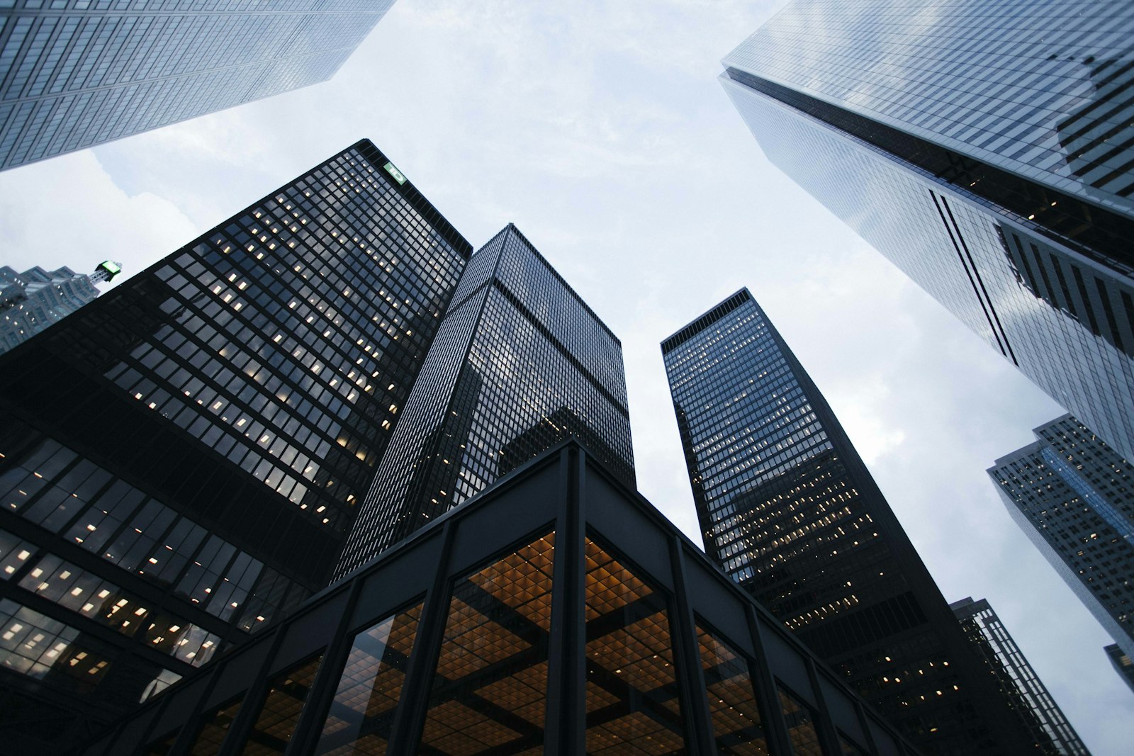 Looking up at modern glass towers against the sky