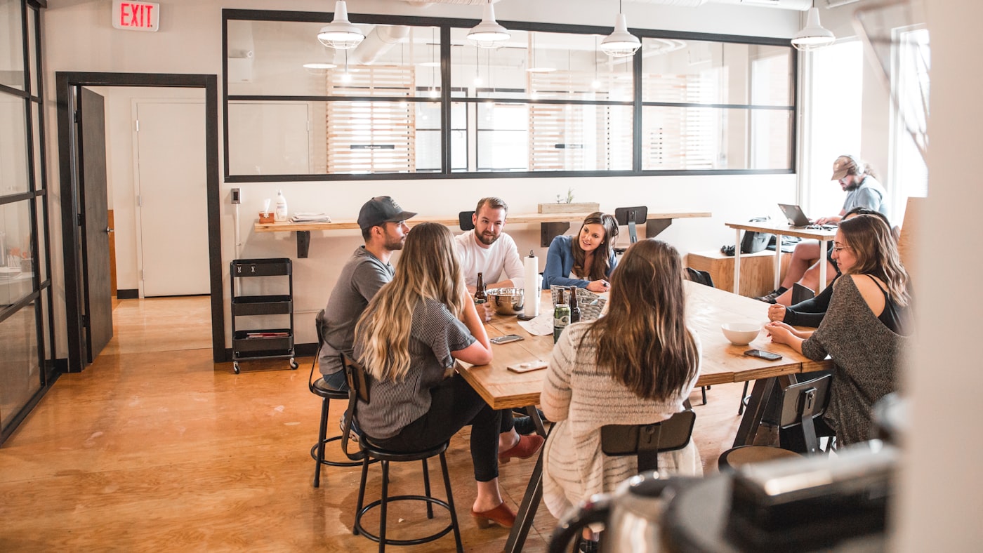 Colleagues talking around a table in an office